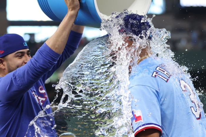 Jun 18, 2023; Arlington, Texas, USA; Texas Rangers center fielder Leody Taveras (3) has water poured on him by starting pitcher Martin Perez (54) after the game against the Toronto Blue Jays at Globe Life Field. Mandatory Credit: Tim Heitman-USA TODAY Sports